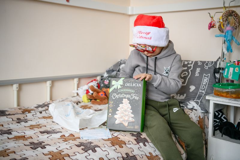 A young boy holds a package of gingerbread
