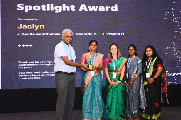 Benita with team getting spotlight award