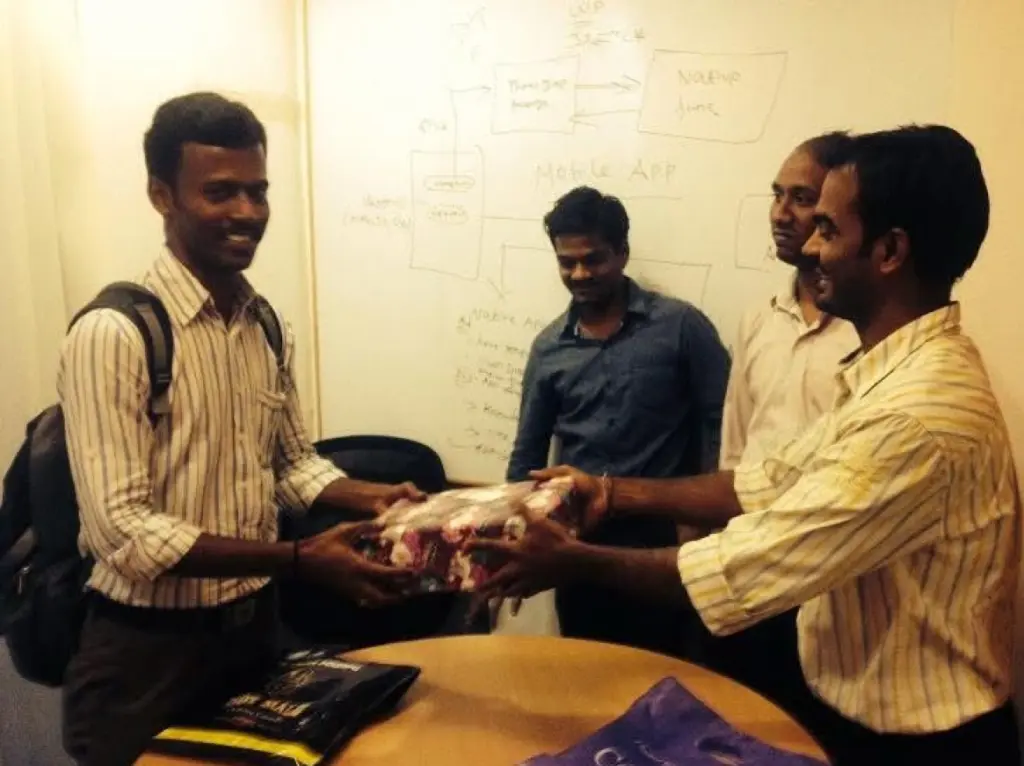 Kailash Ponnusamy presenting a gift