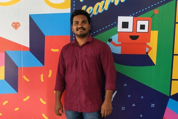 Bhuvanesh valarman standing in front of cody banner