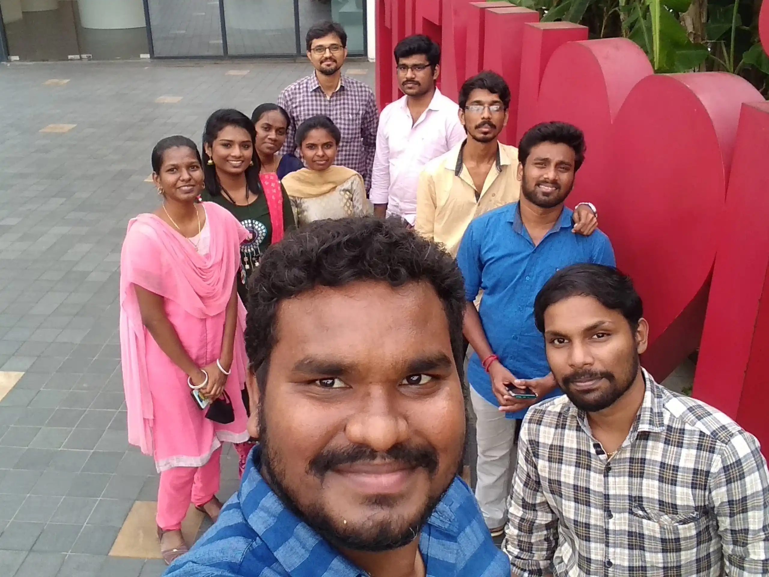 Bhuvanesh valarman with office friends in a mall outside