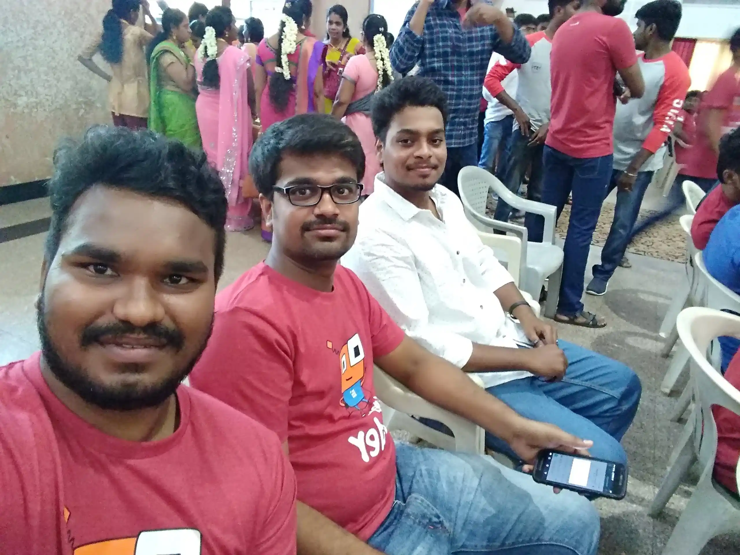 Bhuvanesh valarman with office mates sitting in chair in an event