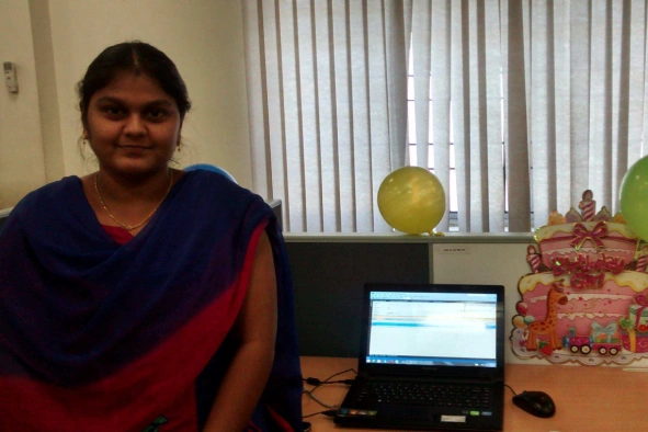 Farjana in her working space with laptop