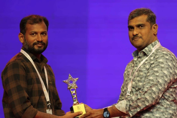 Jegan Raj receiving award from Balaji