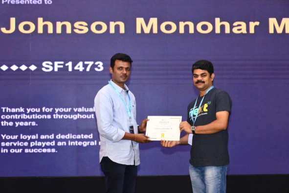 Johnson Manohar receiving a certificate from Vijayanand