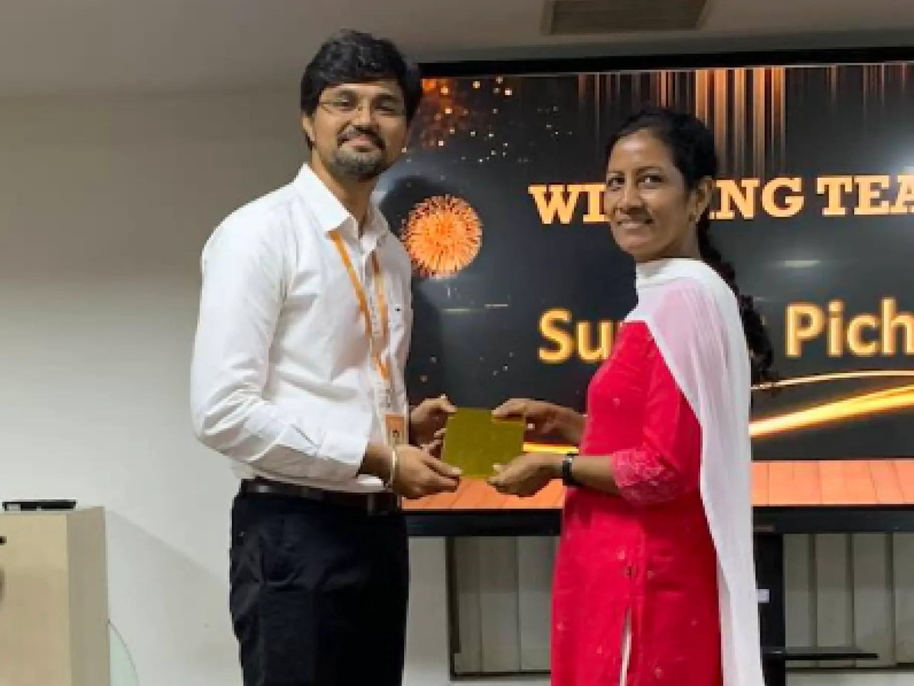 Johnsy Jeya Sophia Joseph Raj Receiving an Award From Baskaran