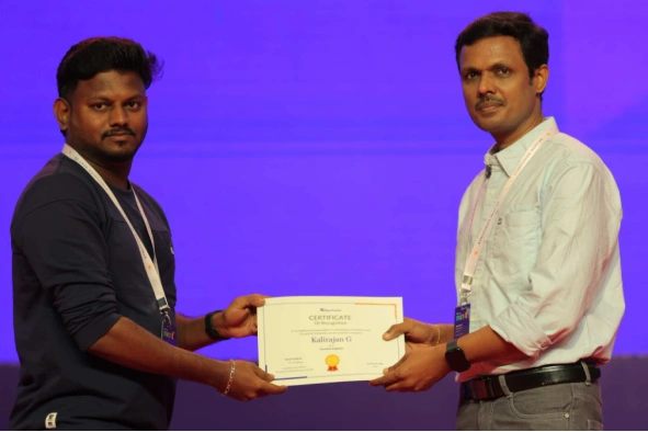 Kalirajan Ganesan receiving a certificate from Vijayanand