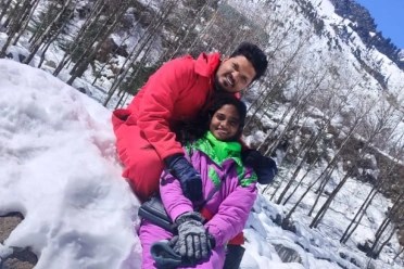 Karthik Anandan with wife in snow‌