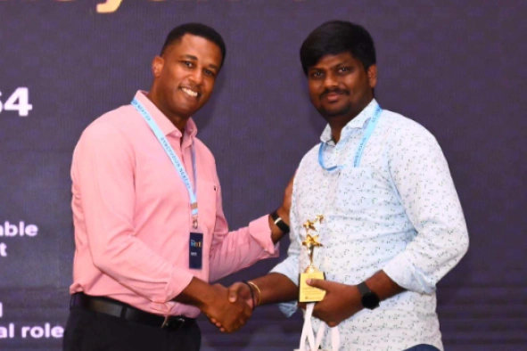 Karthikeyan getting award from a person in next event