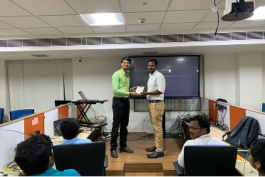 Mahendran Shanmugam Receiving an Award from Baskaran