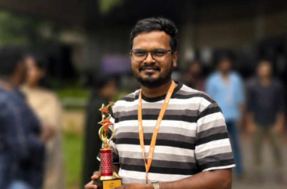 Mahendran Shanmugam Holding an Award