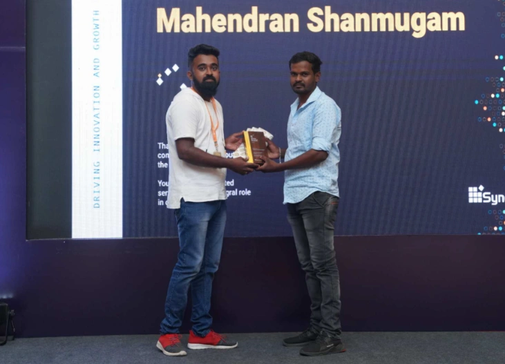 Mahendran Shanmugam Receiving an Award From Michael Prabhu
