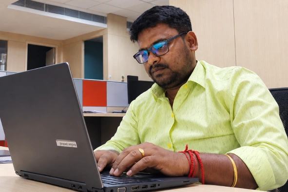 Manikandan Selvaraj looking at his laptop