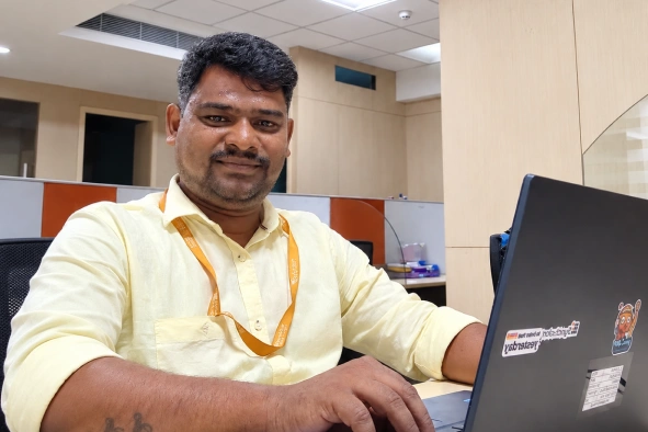Manikandan Selvaraj working in the laptop