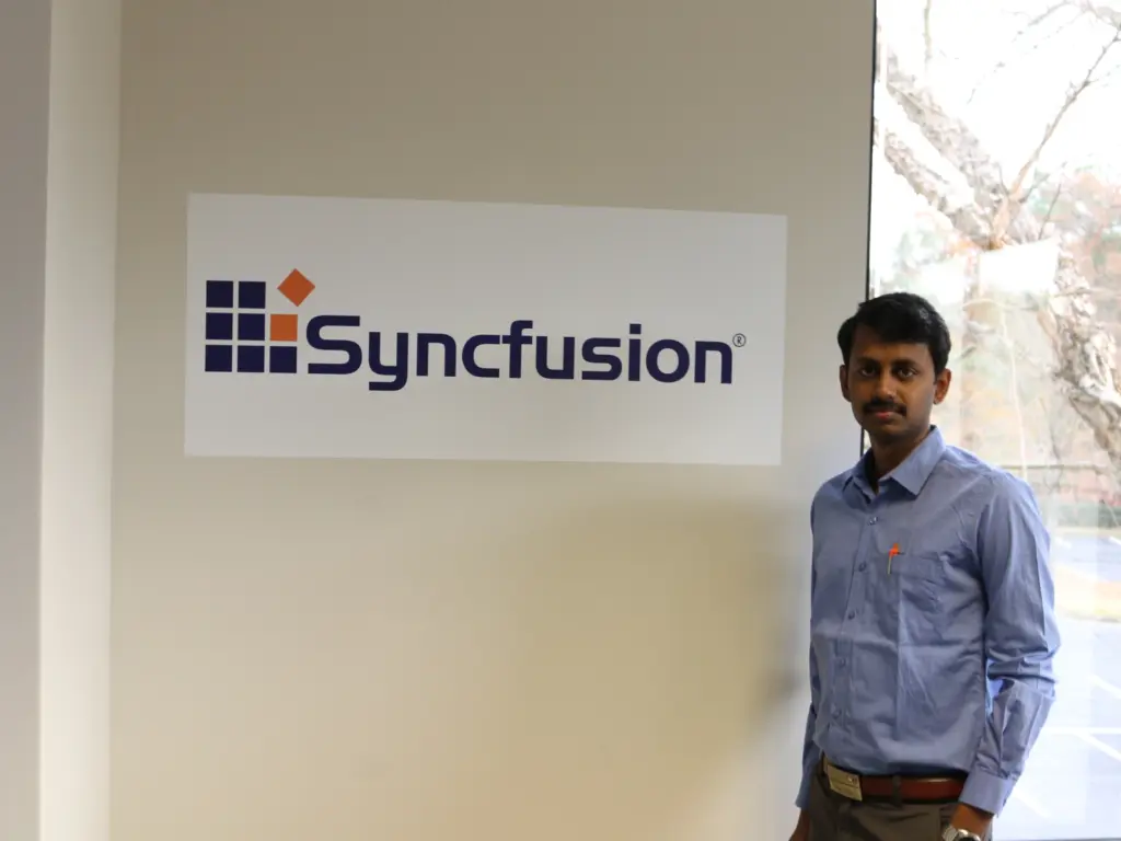 Meikanda Nayanar standing near the Syncfusion banner