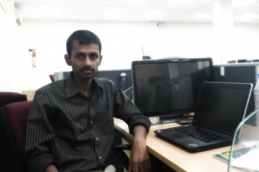 Meikanda Nayanar working in his laptop