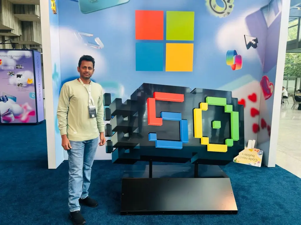 Meikandan Standing with Microsoft Logo