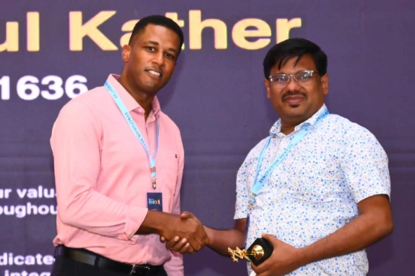 Mohamed Abdul receiving award from a person