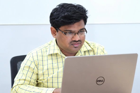 Mohamed Abdul working in his laptop