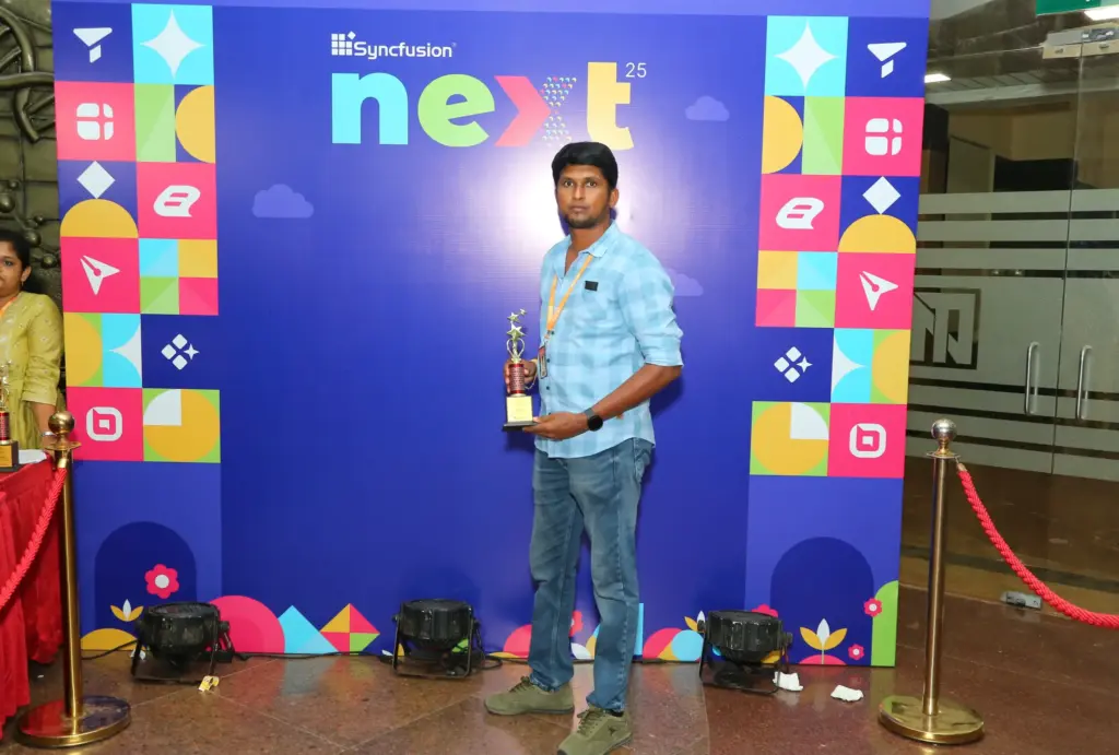 Ranjith Maniarasu Holding an Award at NEXT Event