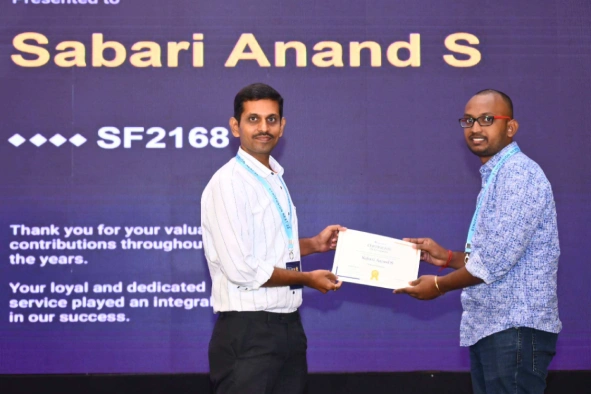 Sabari Anand receiving a certificate