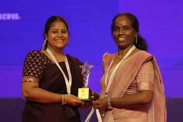 Sangeetha P receiving an award from Saigeetha