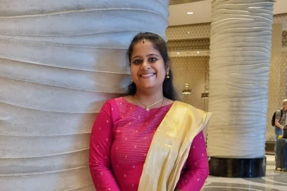 Sangeetha Parameswaran standing in front of wall