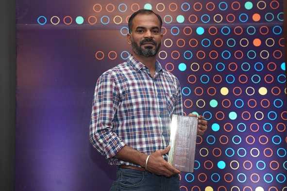 Saravanan ganesan holding an award