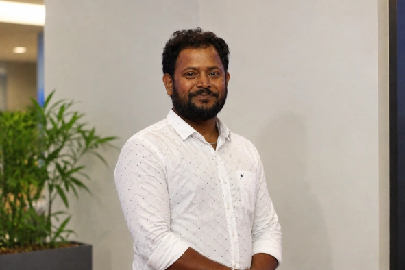 Vengatesh Maniraj standing in the office space