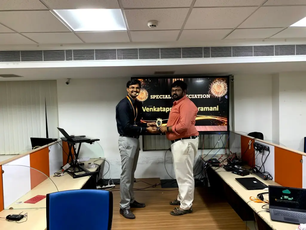 Venkataprasad Subramani Receiving a Certificate From Baskaran