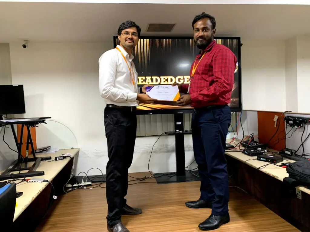 Vikas Sekar Receiving a Certificate from Baskaran