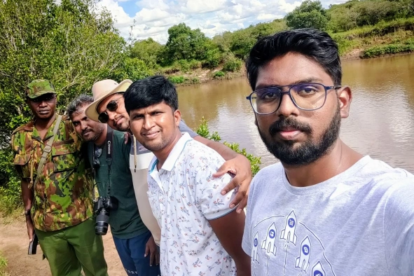 Vinoth with team in trip behind lake