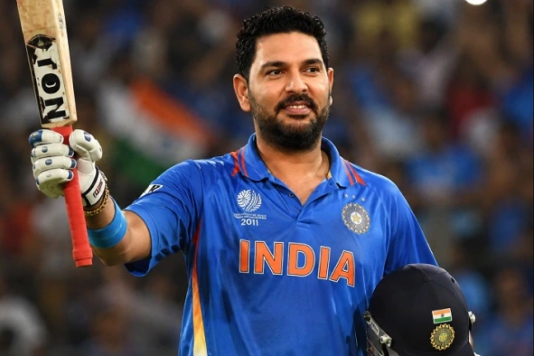 Yuvaraj singh in cricket outfit having bat and cap in hand