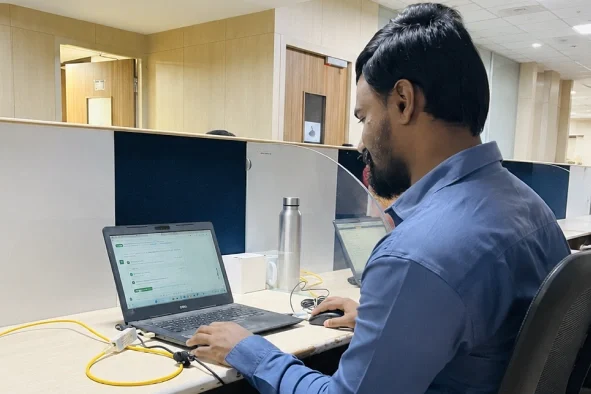 Sasi kumar working in his laptop